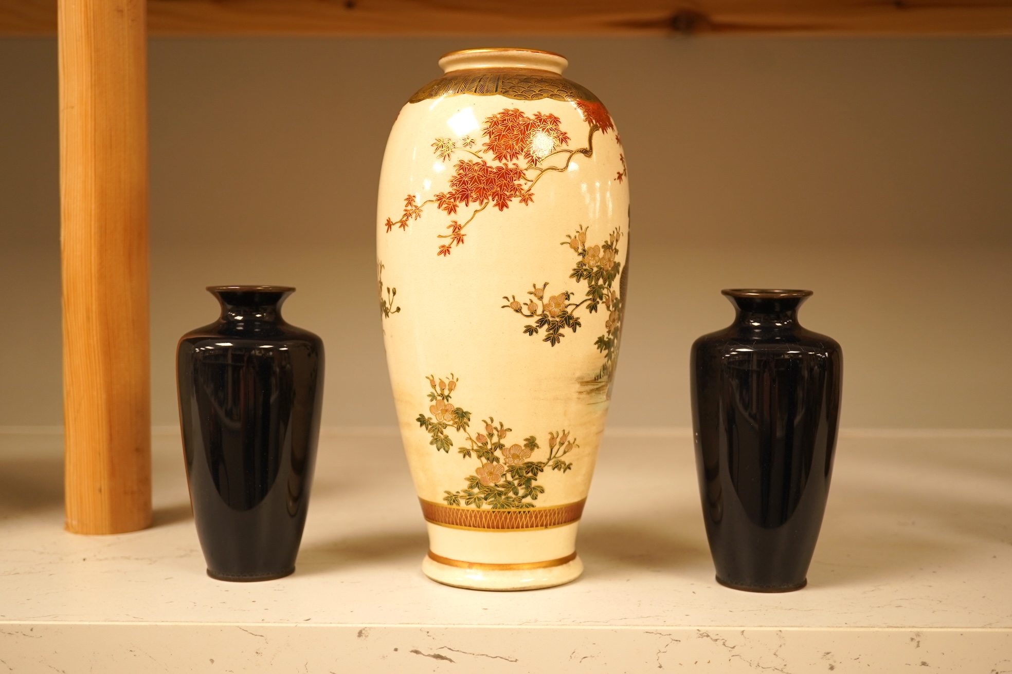 A Japanese figural satsuma vase and a pair of small black cloisonné enamel vases, Satsuma 21.5cm high